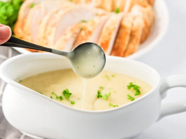Spooning turkey gravy without drippings from a gravy boat.