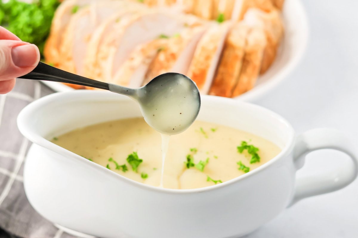 Spooning turkey gravy without drippings in a gravy boat.