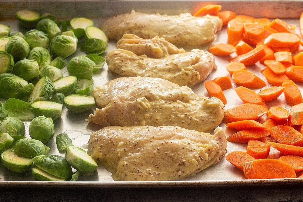 Honey mustard chicken on a sheet pan with vegetables
