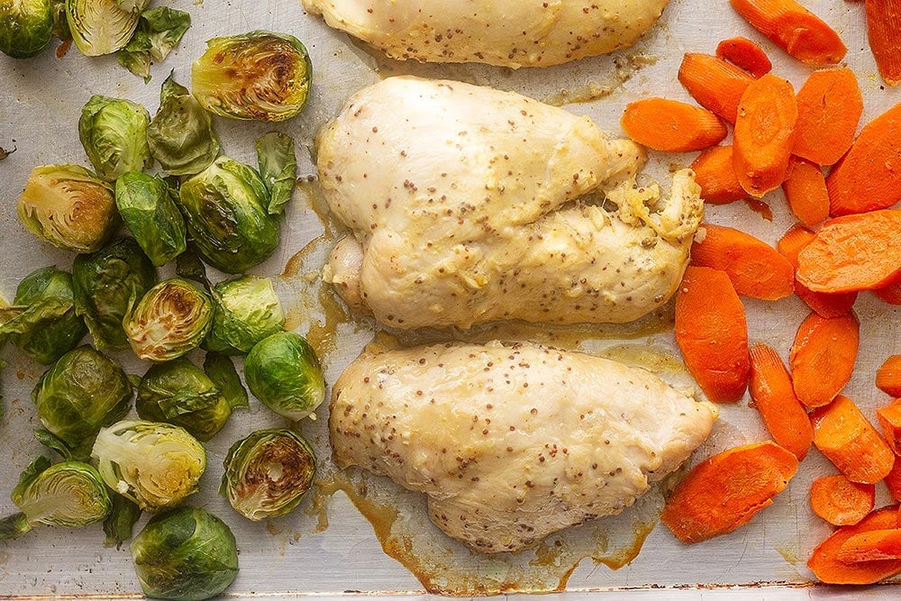 Chicken Breast Recipes - Baked honey mustard chicken on a sheet pan with carrots.