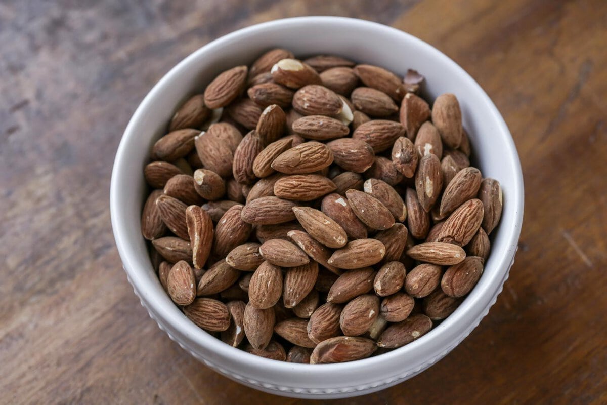 A white bowl of almonds.