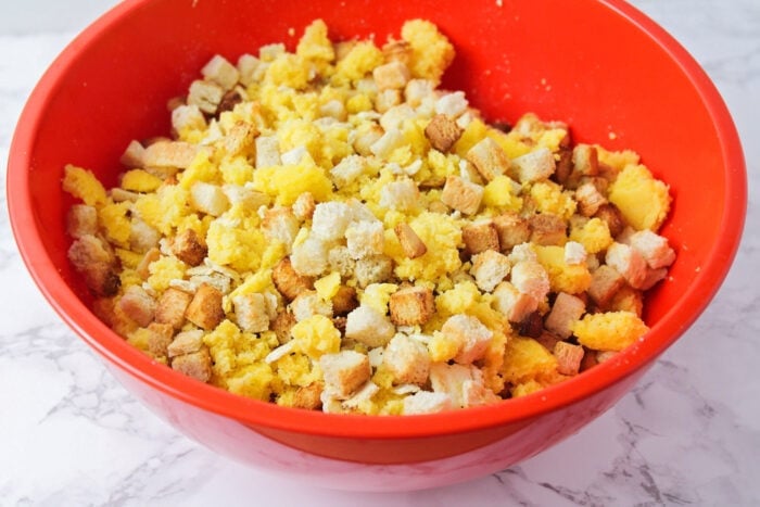 Savory cornbread stuffing is the perfect side dish, especially for holiday meals! The texture is perfect and the flavor is delicious! Cornbread stuffing ingredients in a mixing bowl