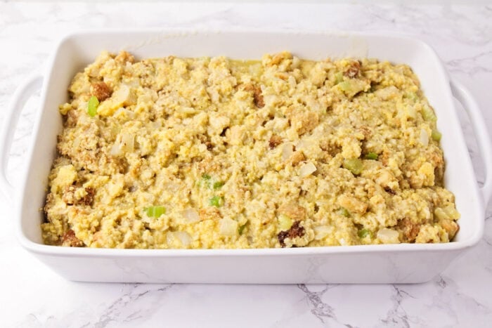 Savory cornbread stuffing is the perfect side dish, especially for holiday meals! The texture is perfect and the flavor is delicious! Stuffing mixture in a casserole dish before baking
