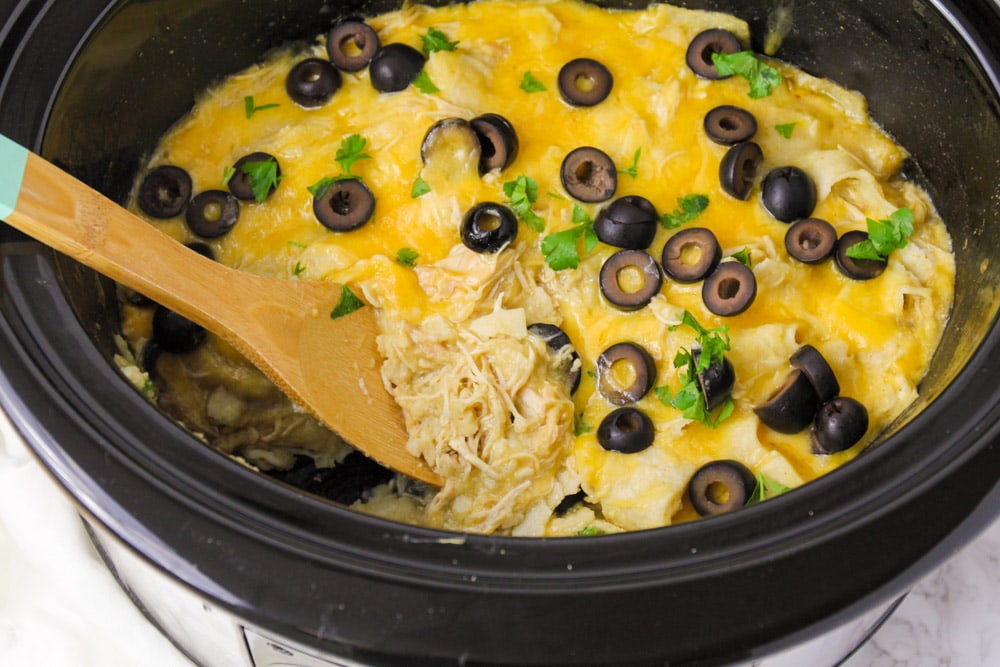 Crockpot dinner ideas - slow cooker chicken enchiladas with black olives on top.