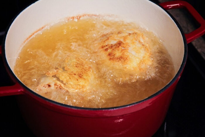 Frying chicken in a dutch oven filled wtih oil.