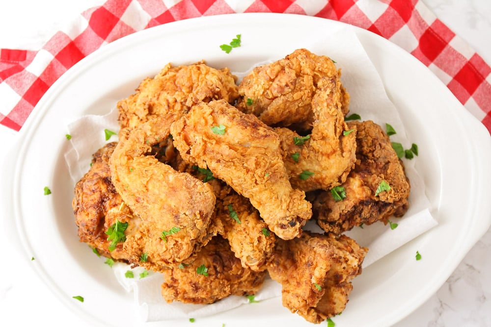 Buttermilk fried chicken recipe served on a white plate.