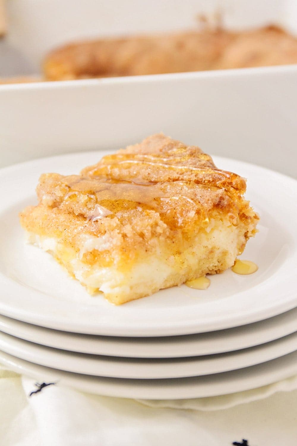Slice of sopapilla cheesecake recipe drizzled with honey