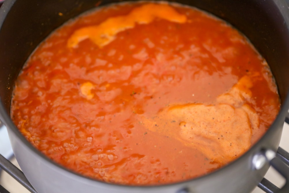 Tomato bisque recipe cooking in a pot.