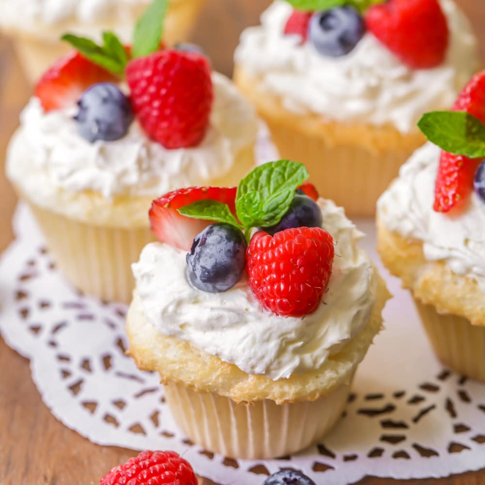 Angel food cupcakes with whipped topping and berries