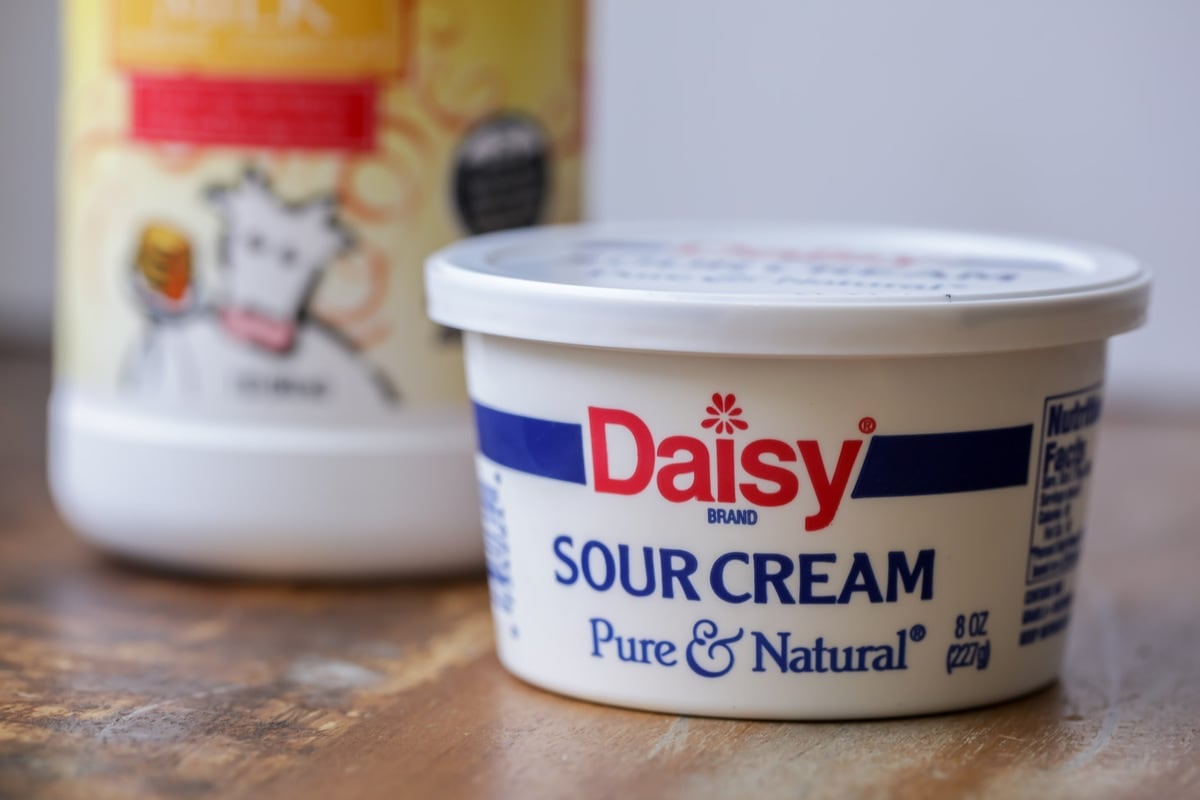 A container of sour cream and buttermilk on a counter.