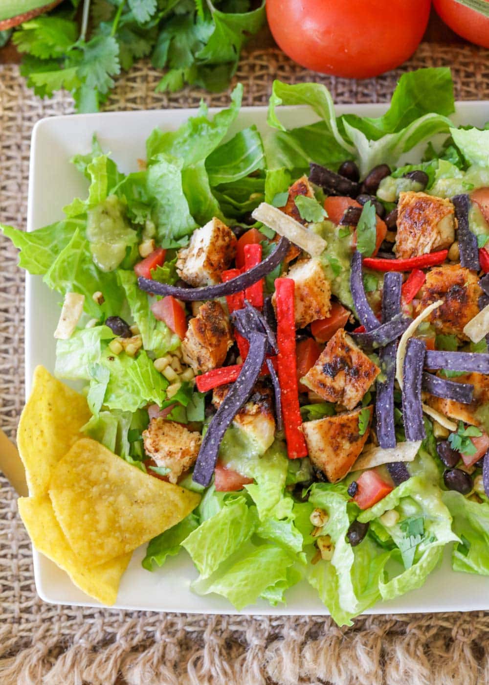 Overhead shot of chicken taco salad on a white plate