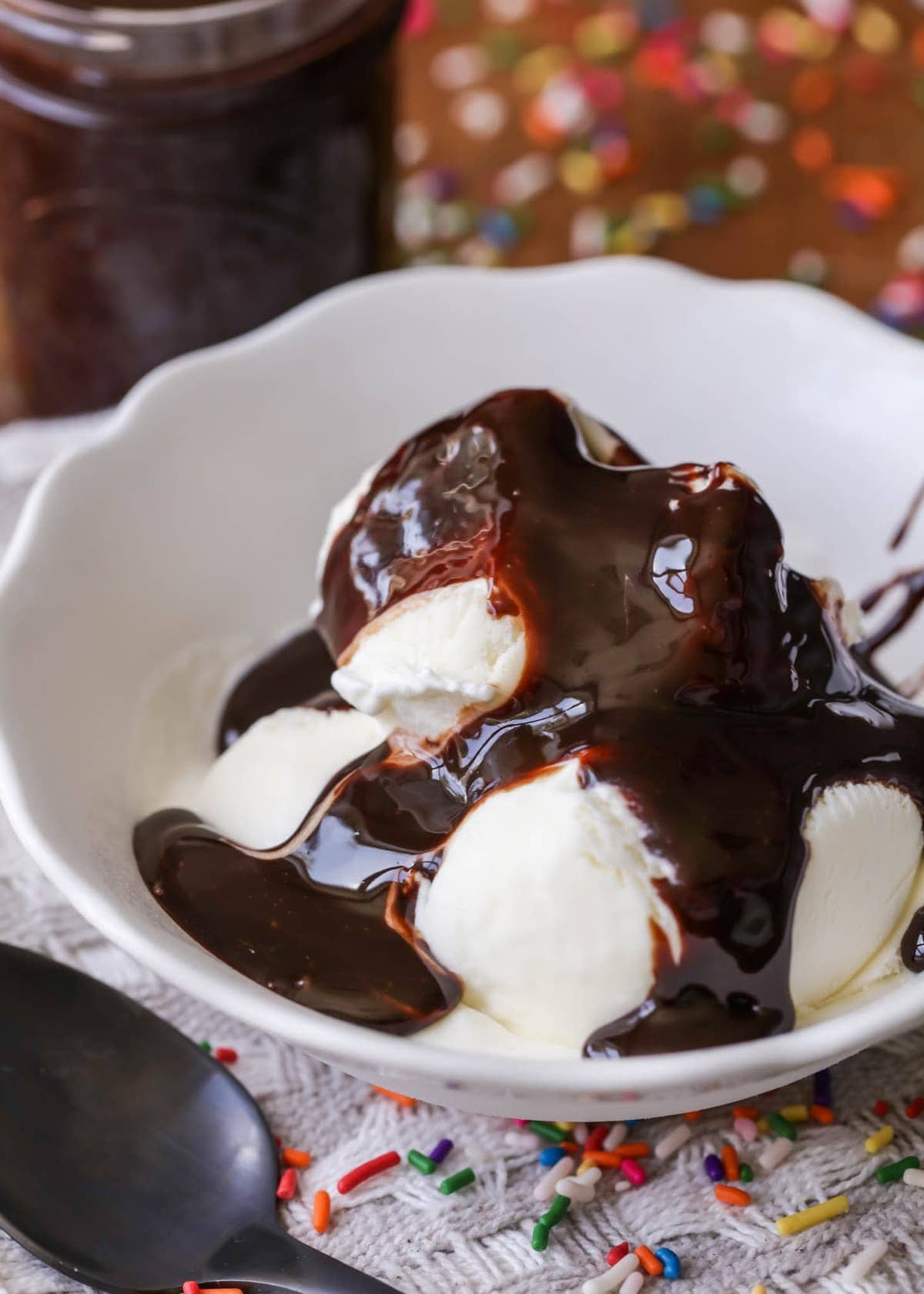 Homemade chocolate syrup poured over vanilla ice cream