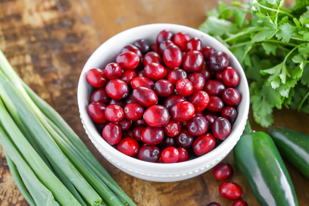 A bowl full of cranberries to use in cranberry salsa recipe