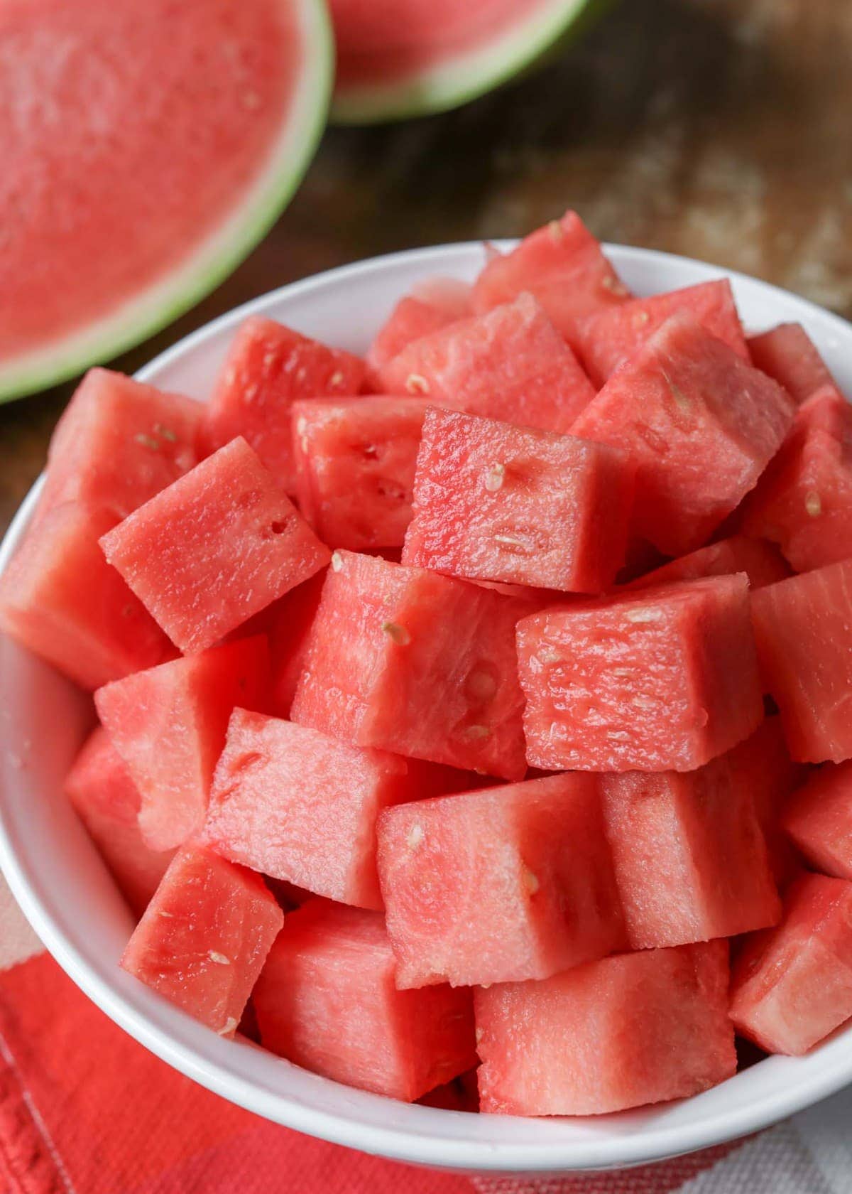 Close up of watermelon cubes in a white bowl.