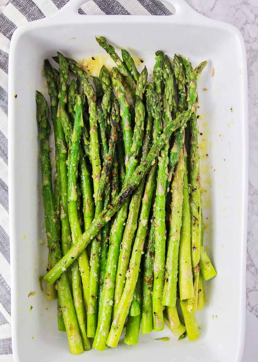 Grilled asparagus recipe in a white serving dish