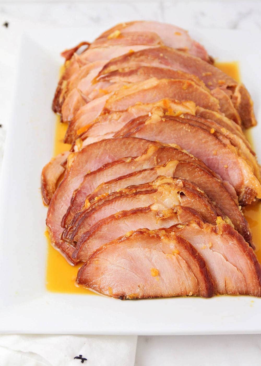 Instant pot spiral ham sliced on a serving platter.
