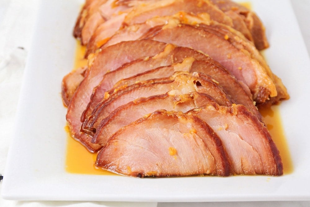 Sliced ham on a white plate. 