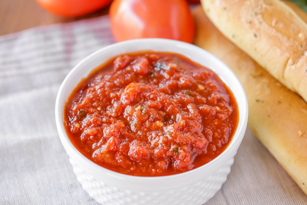 Homemade marinara sauce in a white ramekin.