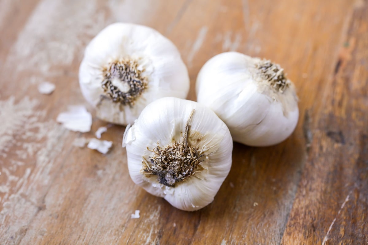 Garlic cloves on a wooden counter.