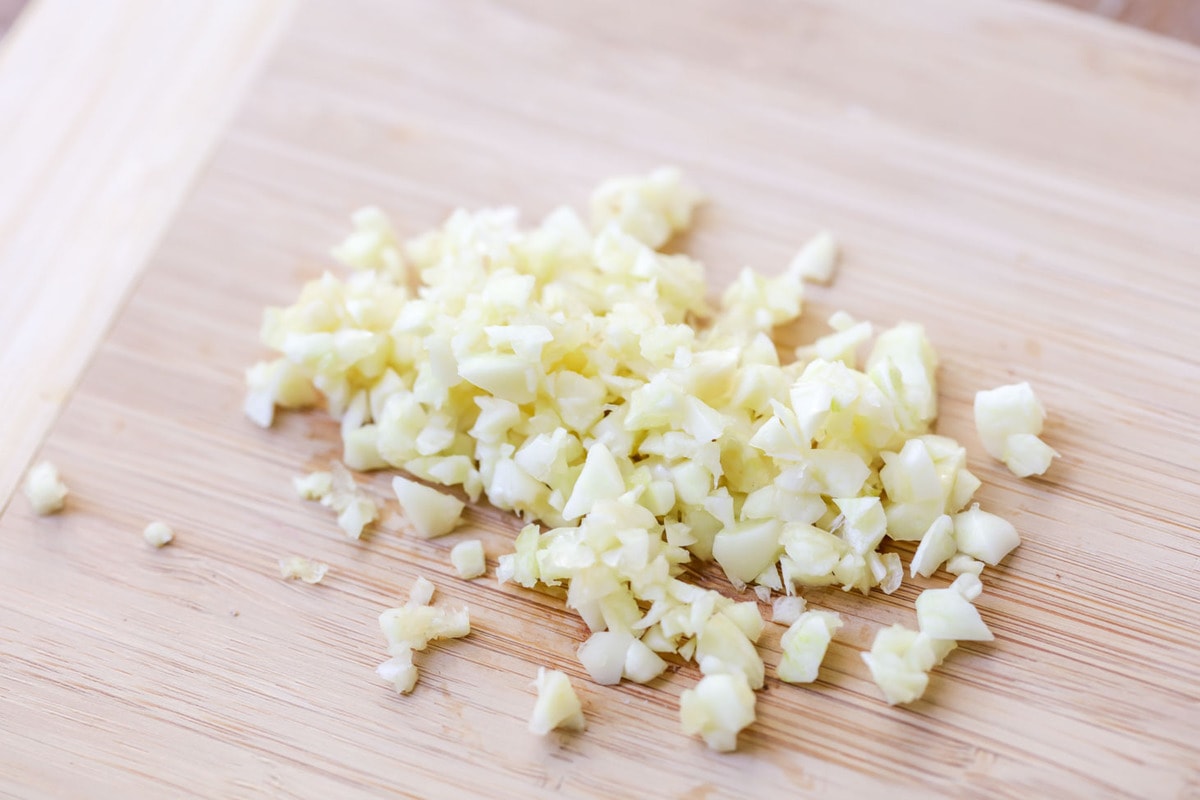 Minced garlic on a cutting board.