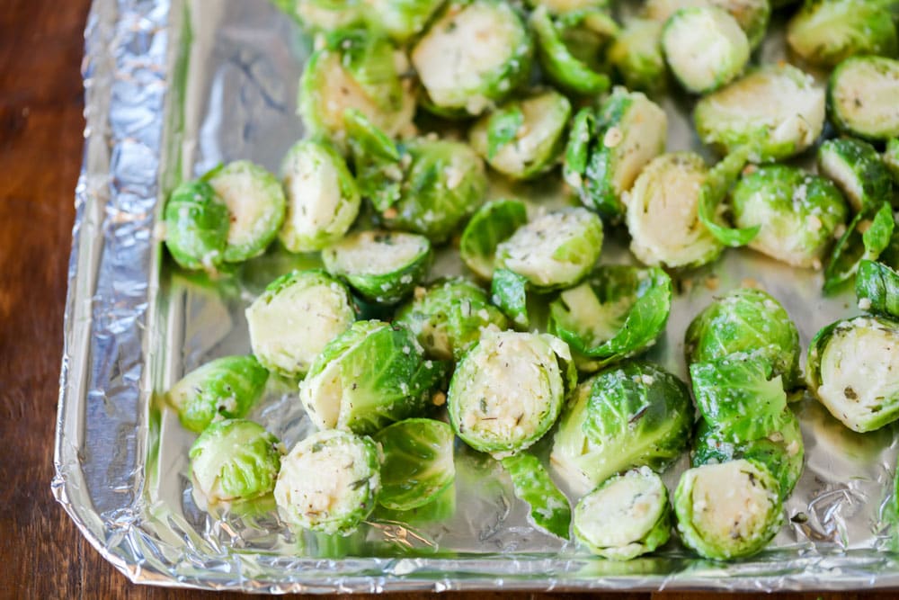Brussel sprouts on a baking sheet ready to be roasted