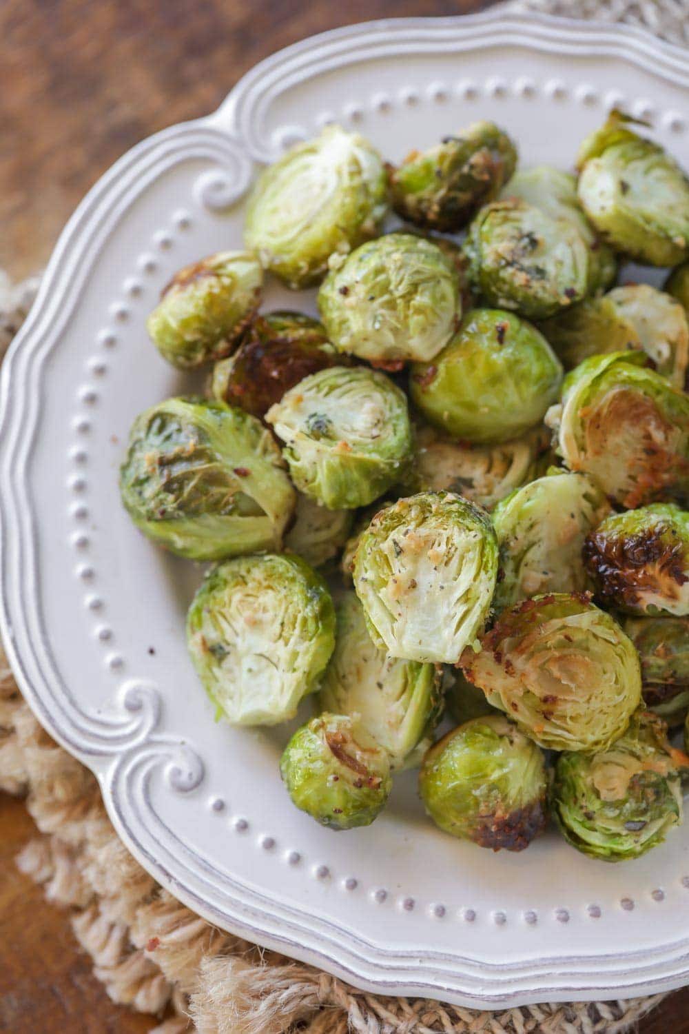 Close up of parmesan brussel sprouts on a white plate