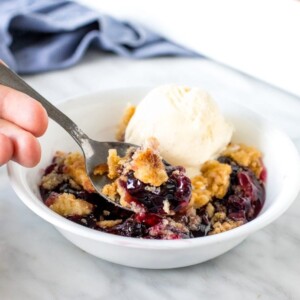 Close up of a spoonfull of blueberry dump cake.