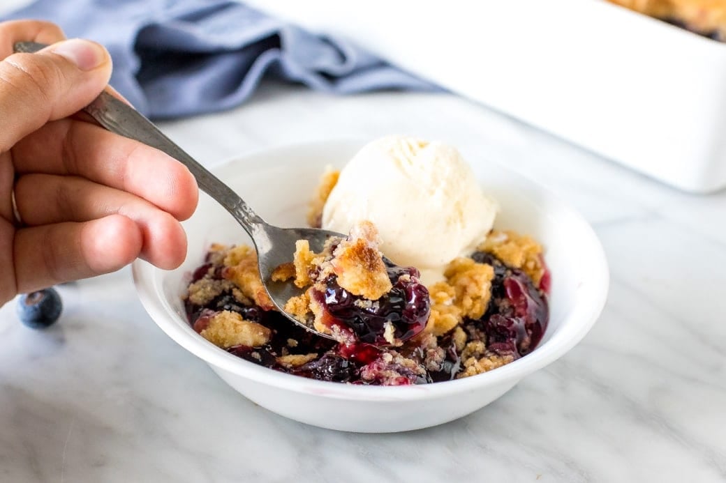 4th of July Desserts - Close up of a spoonful of blueberry dump cake.