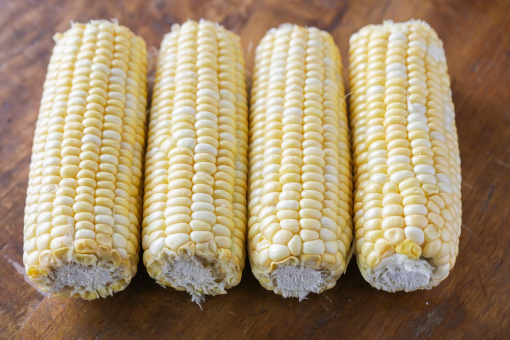 Four cobs of corn ready to be boiled