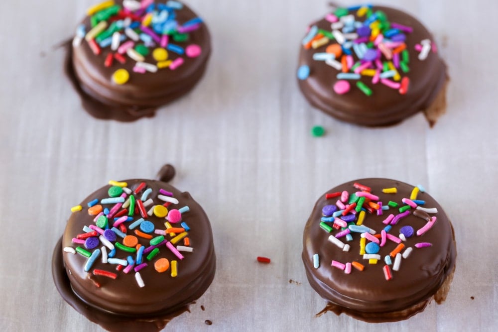 Chocolate dipped oreos topped with sprinkles 