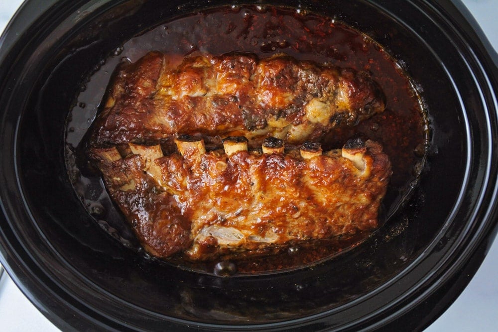 Slow cooker ribs after being cooked in the slow cooker.