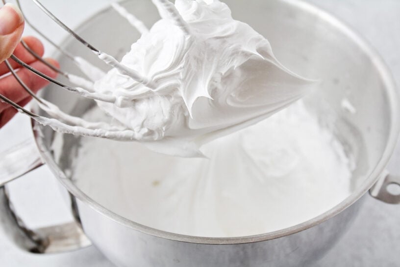 Light, airy meringue cookies made with just 5 ingredients are crisp, sweet, and perfect for holidays, showers, or gifting! Egg whites being mixed with a stand mixture