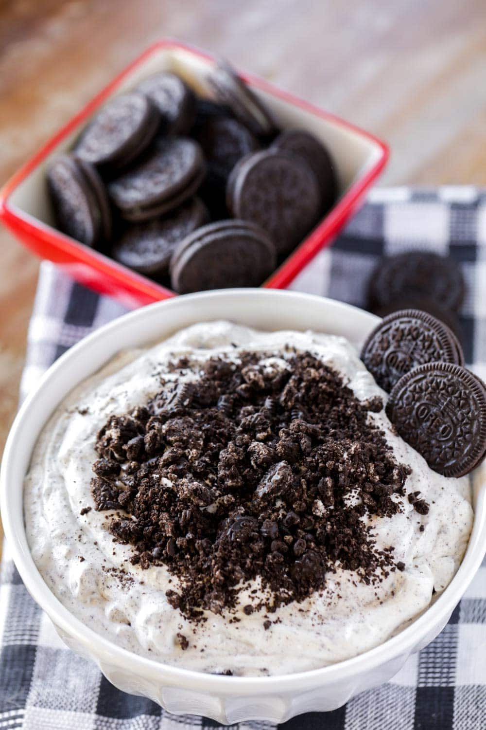 Oreo fluff dessert topped with crushed oreos in a white bowl 