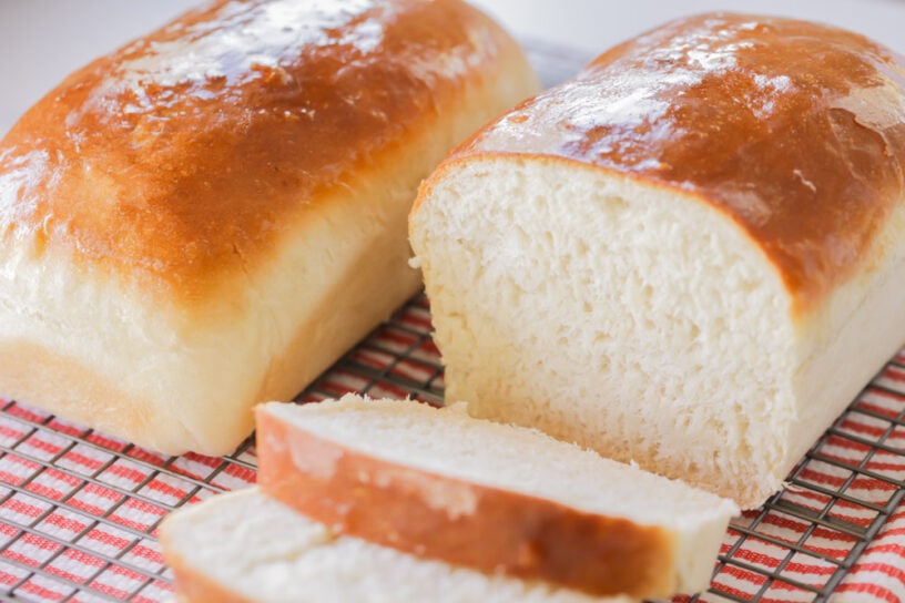 A loaf of homemade bread cut into slices