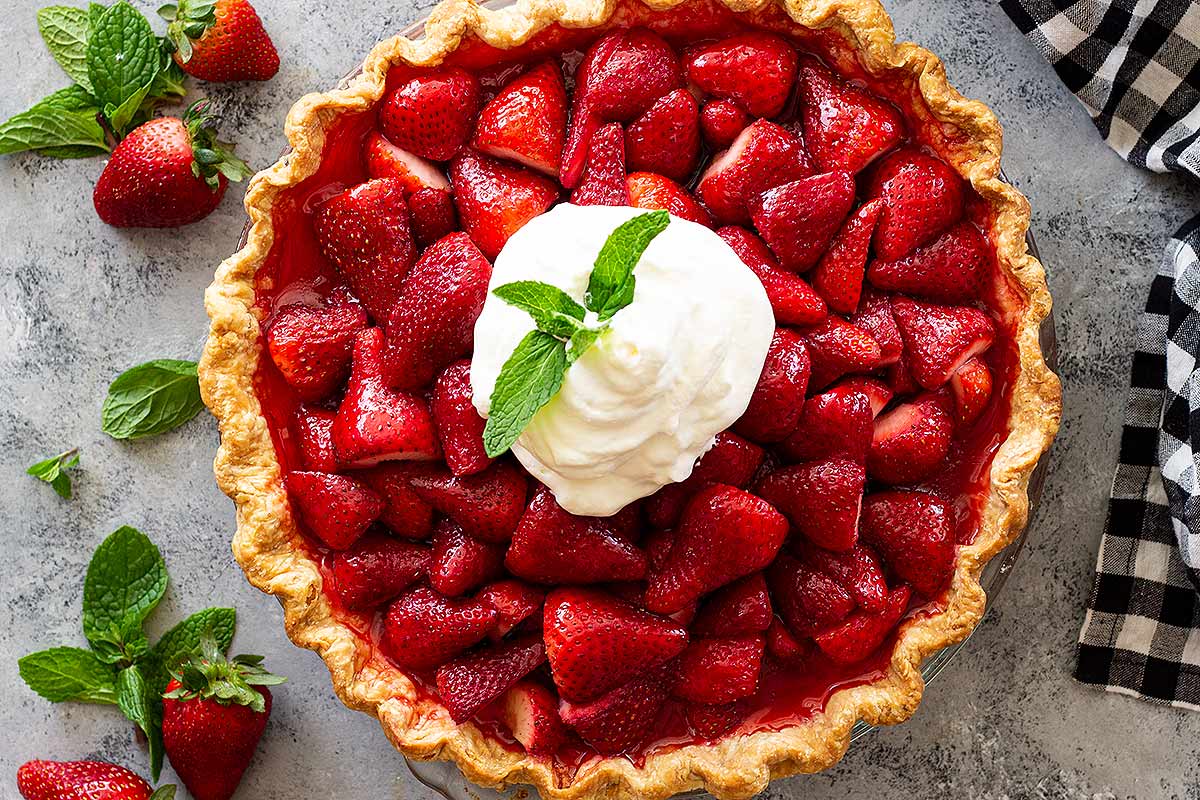 Strawberry pie with jello topped with whipped cream