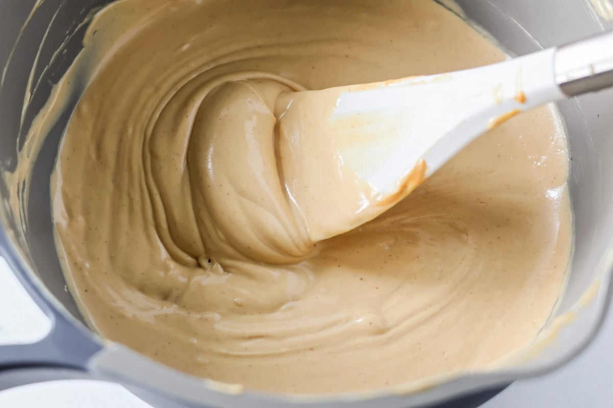 Melted peanut butter and white chocolate mixed together in pot.