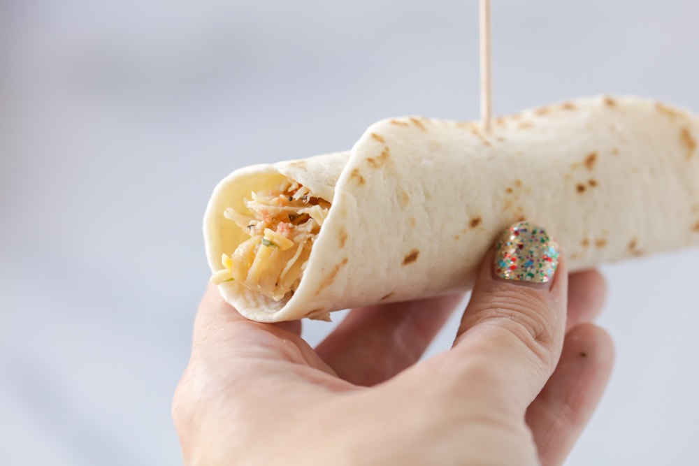 Rolling a chicken flauta and securing it with a toothpick