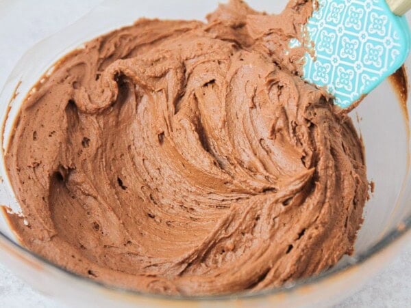 Chocolate buttercream frosting whipped in a bowl.