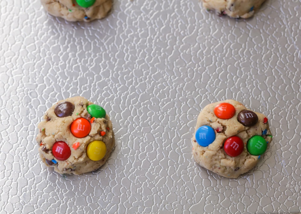 How to make M&M cookies process image - scooped dough with M&Ms on top.