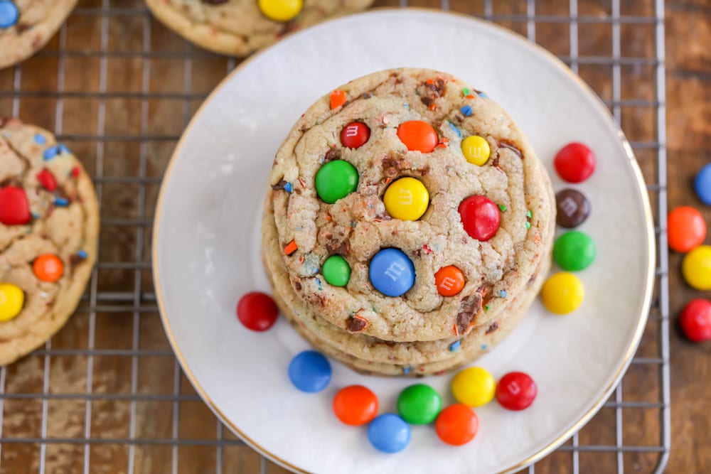 M&M cookies recipe stacked on white plate.