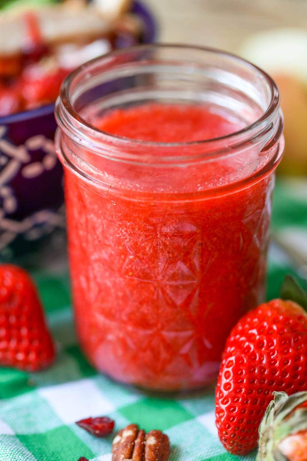 Close up of strawberry vinaigrette dressing in a glass jar.