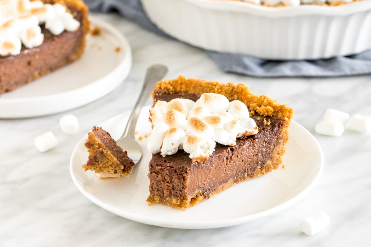 A slice of S'mores Pie on a white plate