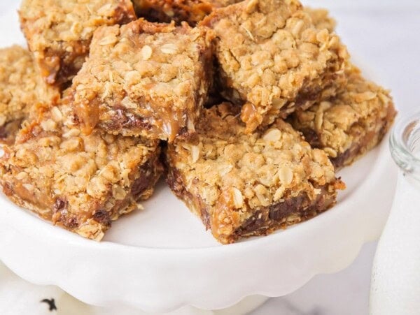 Carmelitas stacked on a white platter.