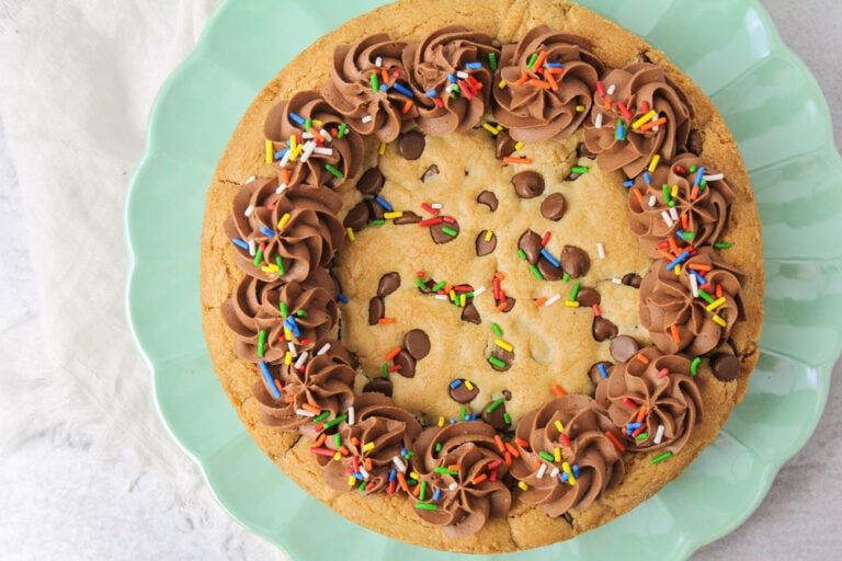 A chocolate chip cookie cake topped with frosting.