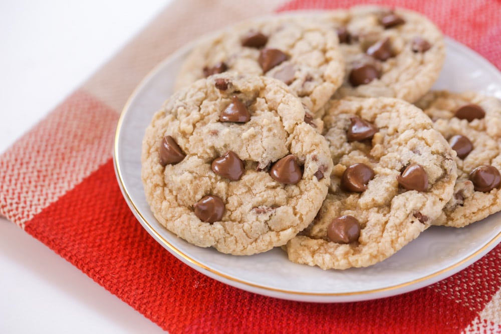 Easy cookie recipes - eggless chocolate chip cookies stacked on a white plate.