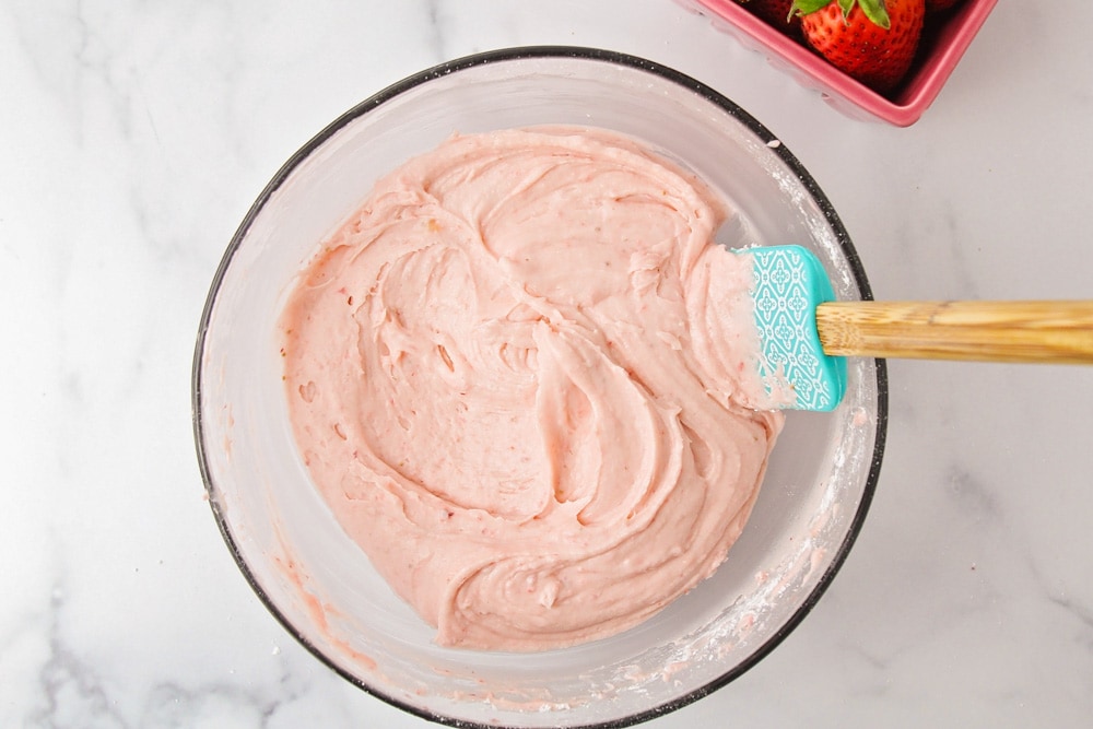 Strawberry buttercream frosting in glass bowl