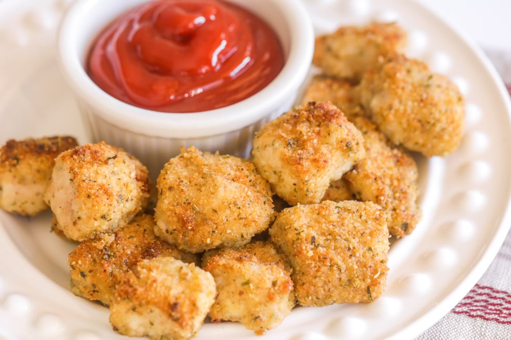 Healthy Dinner Ideas - Baked Chicken Nuggets on a white plate with a side of ketchup in a white ramekin.