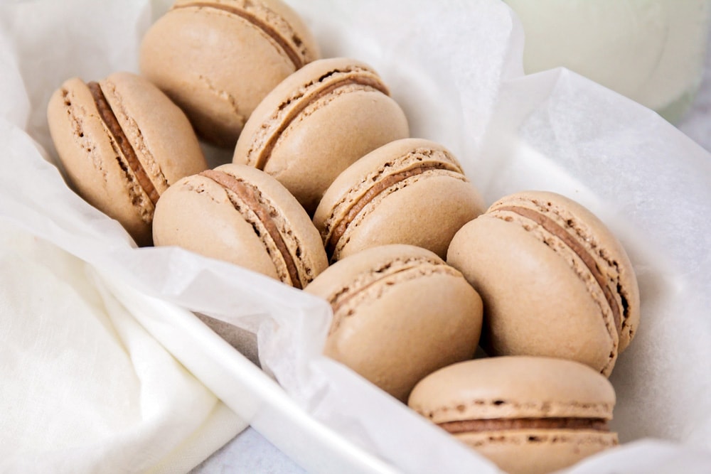 New years eve desserts - chocolate macarons served in a rounded platter.