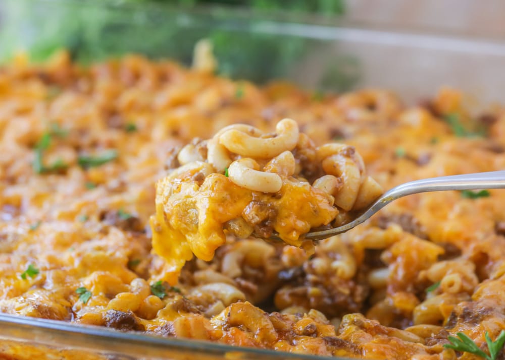 Close up of hamburger casserole scooped out of a baking dish.