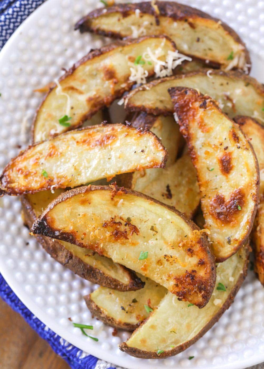 Oven baked potato wedges on a white plate
